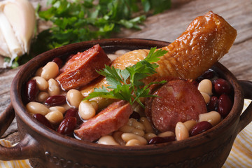 beans with chicken legs and grilled sausages close up horizontal