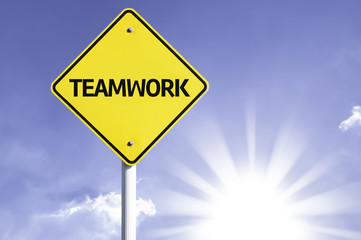 Teamwork road sign with sun background