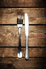 Silver Knife and fork over wooden table with copy space. Diet Fo