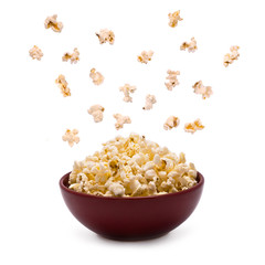 Popcorn in the Bowl explodes isolated on white