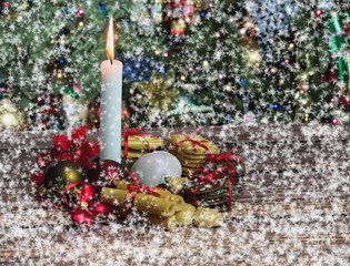 Christmas cookies and candle in snow
