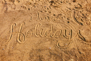 I love Holidays written in golden sand (vacation summer)