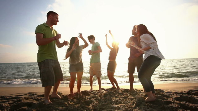 Multiracial Group Dancing at Beach