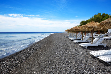 The beach with black volcanic stones at Santorini island, Greece