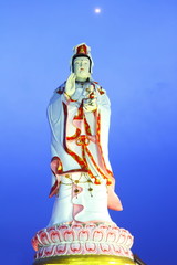 Statue of chineses female god, at twilight of moonlight.