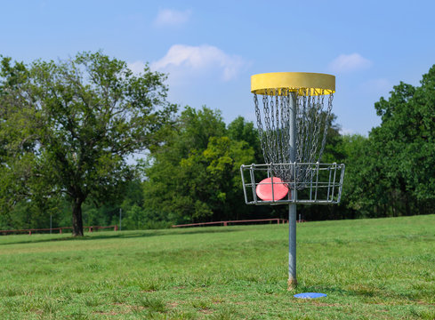 Disc golf basket in a park