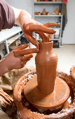 hands of a potter, creating an earthen jar