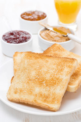 toast with various jams and peanut butter, orange juice