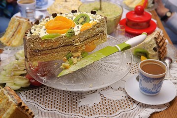 Cake on a glass stand, coffee and knife