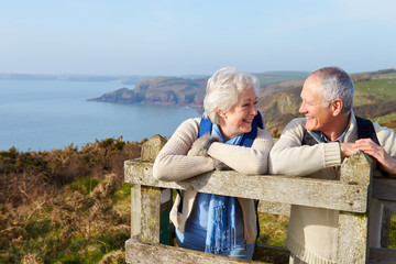 Senior Couple Walking Along Coastal Path