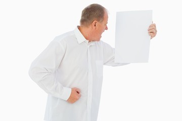 Angry man shouting at piece of paper