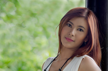 Fototapeta premium Beautiful happy young woman in a park
