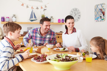 Family Eating Lunch At Kitchen Table