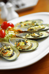 close up asian oyster and cheese roasted in white dish