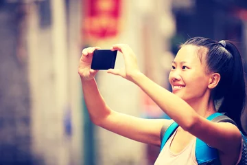 Tuinposter woman tourist taking photo with smart phone in guilin,china  © lzf