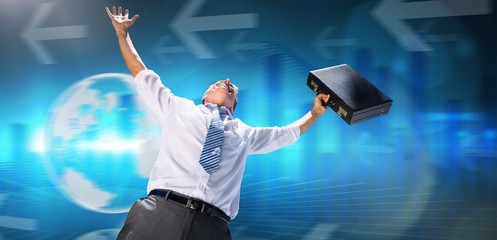 Composite image of businessman holding briefcase and cheering