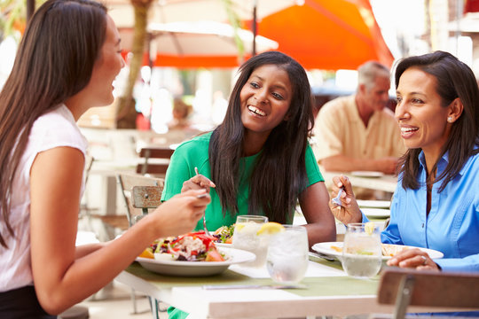 Group Of Female Friends Enjoying Lunch In Outdoor Restaurant