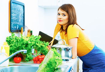 Smiling woman cooking at home kitchen.