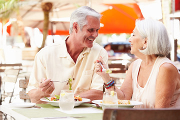 Senior Couple Enjoying Lunch In Outdoor Restaurant