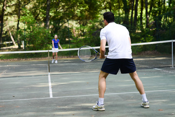 Obraz premium young couple playing tennis outdoor in summer