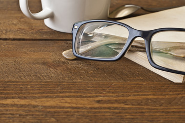 Glasses and book on wood