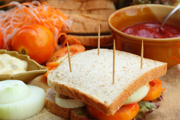 making tuna sandwich with fresh vegetables