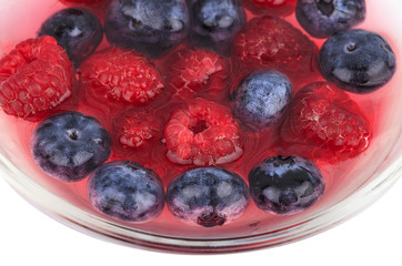 Blueberry and raspberry in a bowl isolated on white