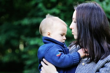 Fototapeta premium Young mother holding her son