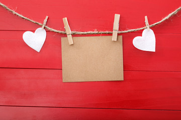 Blank message card and felt hearts with clothespins