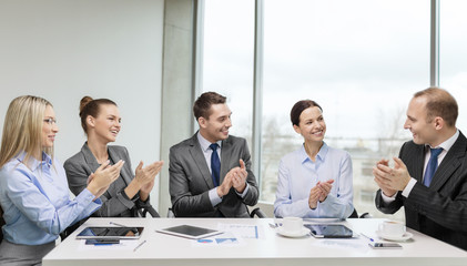 business team with laptop clapping hands