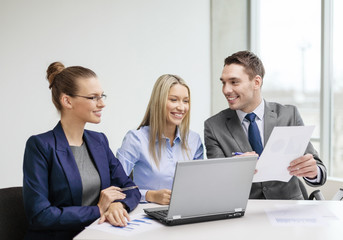 business team with laptop having discussion