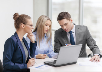 business team with laptop having discussion