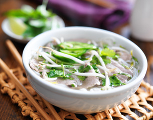 hot bowl of pho with beef and rice noodles