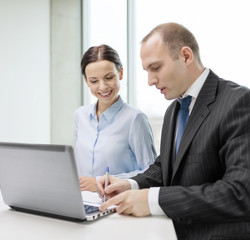 business team with laptop having discussion