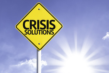 Crisis Solutions road sign with sun background