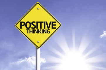 Positive Thinking road sign with sun background
