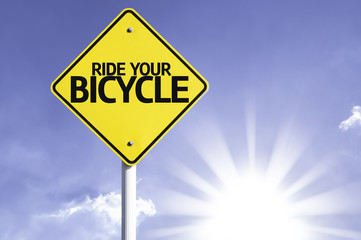 Ride your Bicycle road sign with sun background