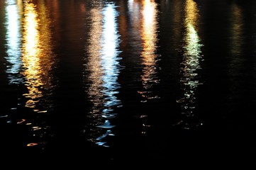 Colorful lights reflecting on sea surface