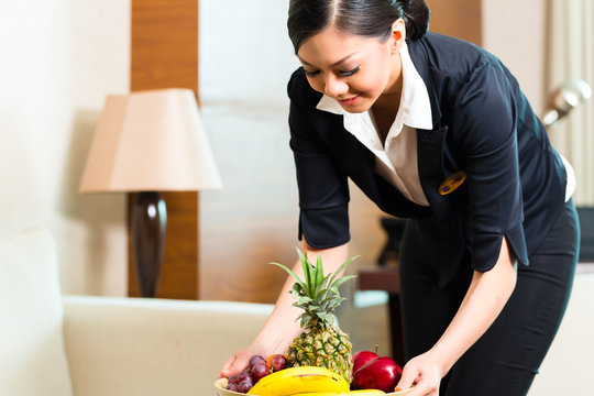 Asian Chinese Hotel Housekeeper Placing Fruit