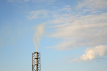 smoke from a chimney on a blue sky