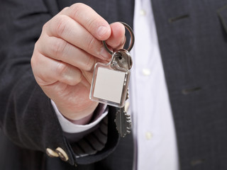 front view of businessman hand with door keychain