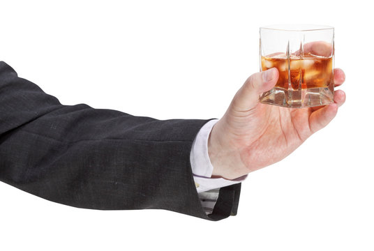 side view of whisky glass in businessman hand