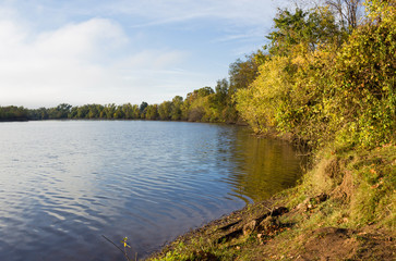 Calm Creek Cove In Autumn With Trees Reflected In Water