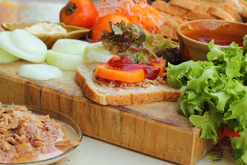 making tuna sandwich with fresh vegetables