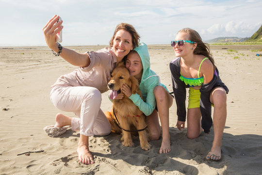 family taking a self portrait at the beach