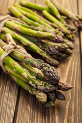 Bunch of young asparagus on wooden table