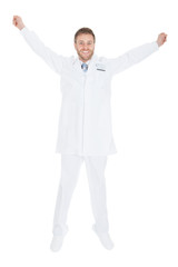 Successful Young Male Doctor With Arms Raised