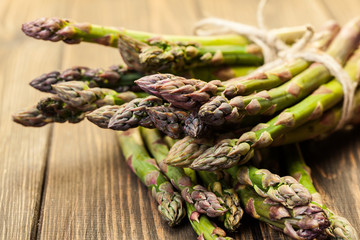Bunch of young asparagus on wooden table