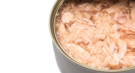 Pieces of tuna fish in a tin can over white background