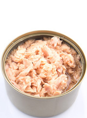 Pieces of tuna fish in a tin can over white background